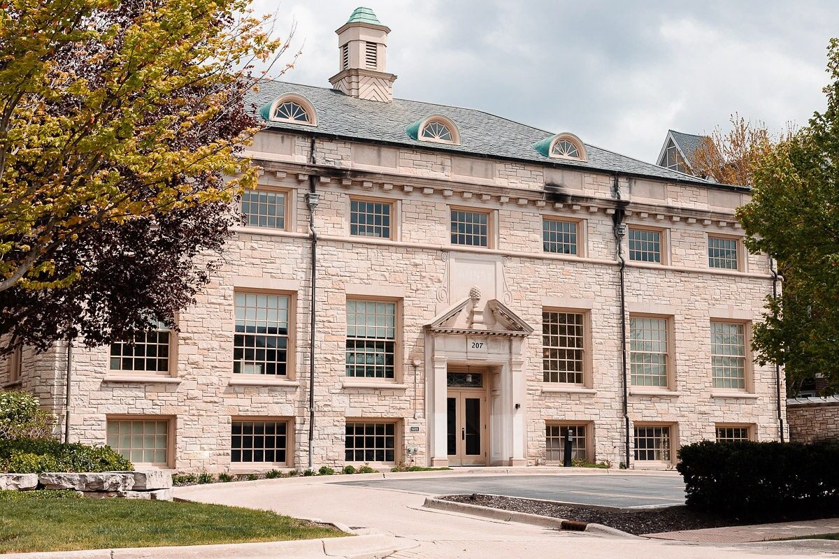 The historic 100-year-old Paulson Wealth office in Wheaton, Illinois, a stone building with a green copper cupola