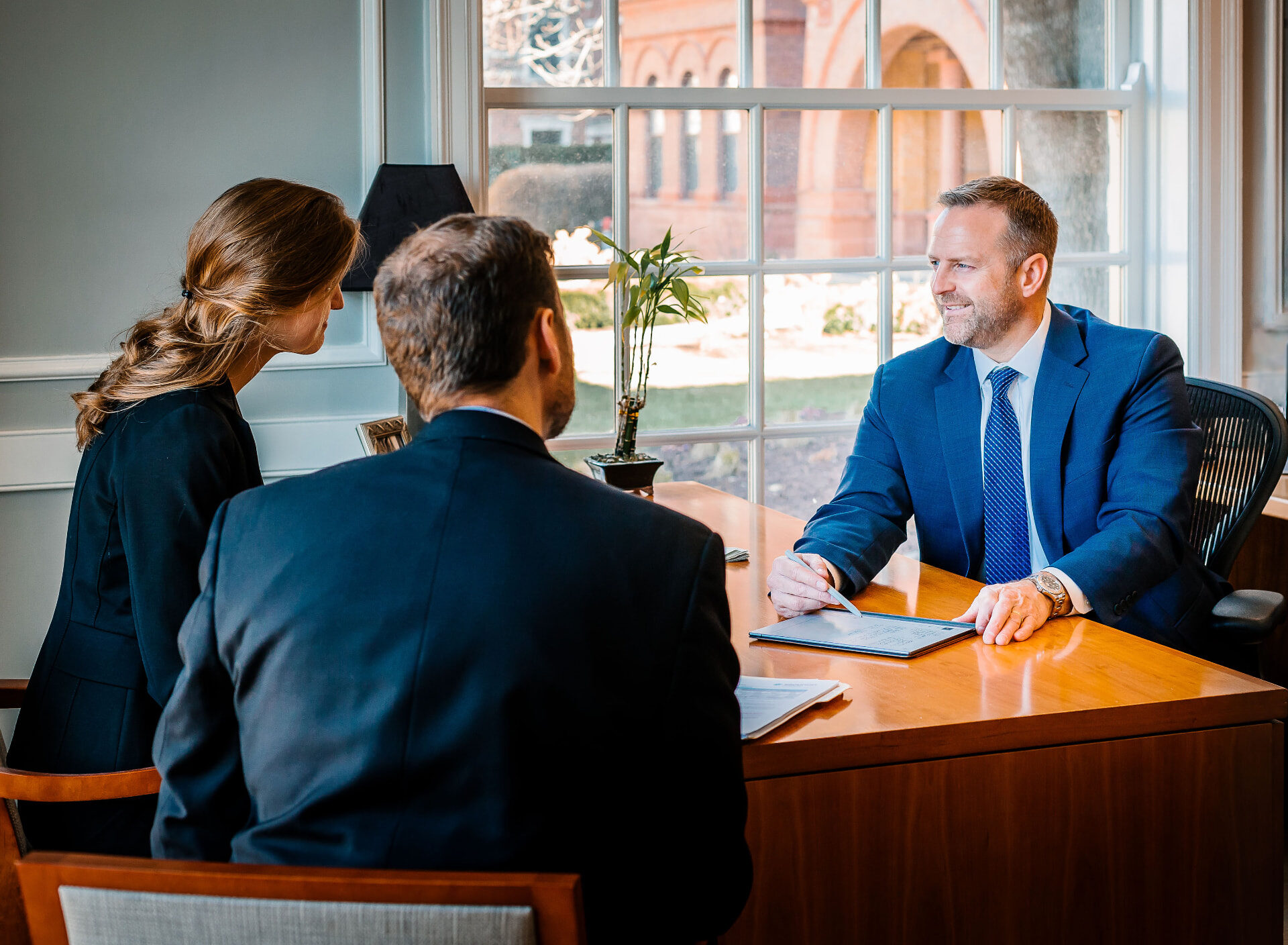 Nate Paulson meeting with clients in the Wheaton office